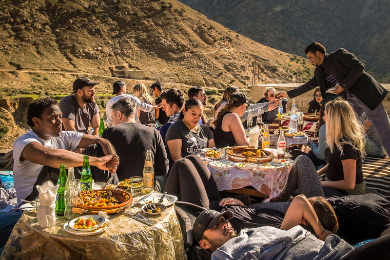 a group of people sitting around a table eating food