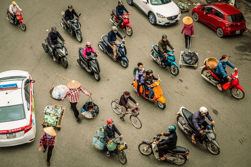 a group of people riding motorcycles down a street