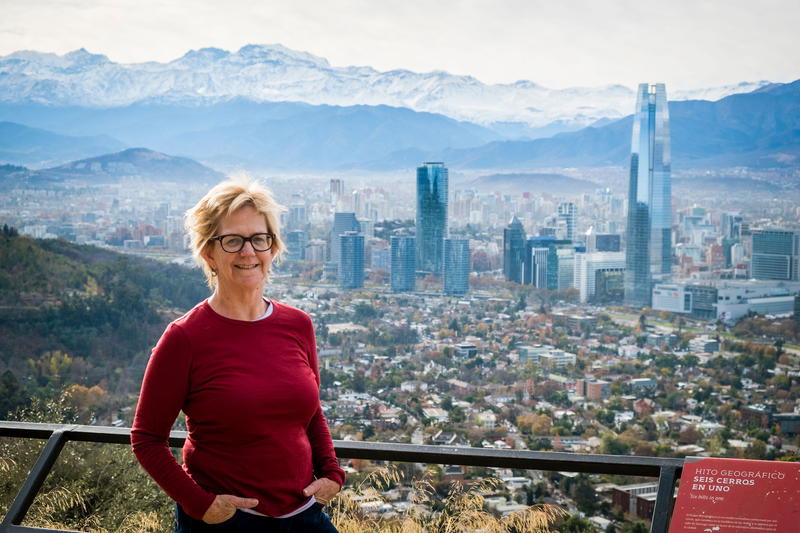 a woman standing in front of a view of a city