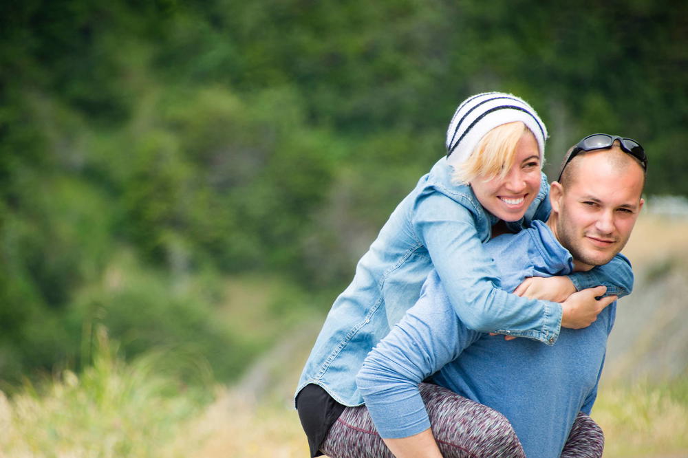 A man is carrying a woman on his back.