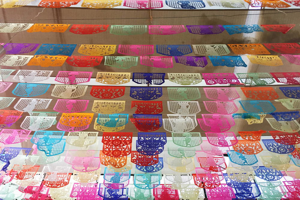 A display of colorful paper lanterns hanging from a window.