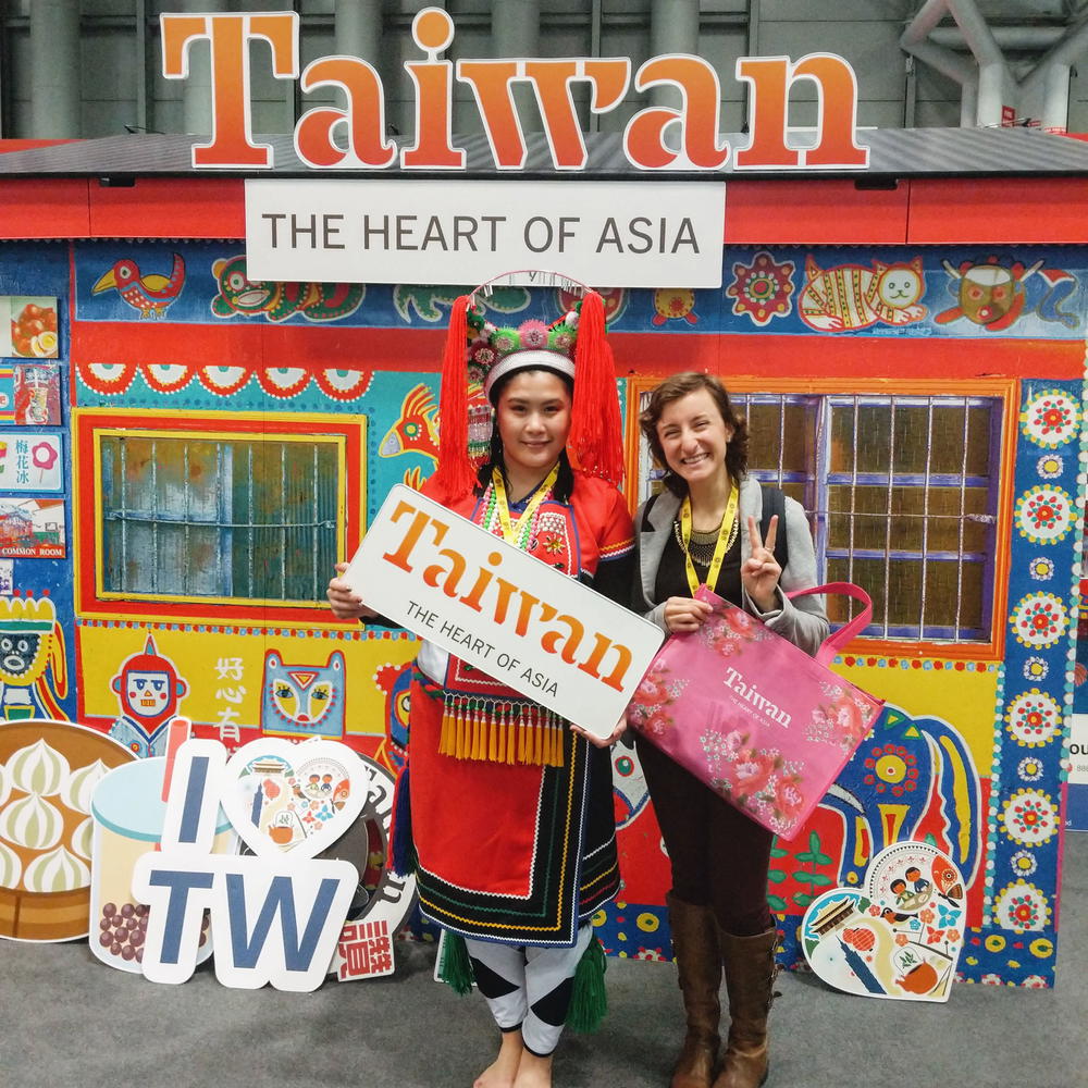 Two women posing in front of taiwan.