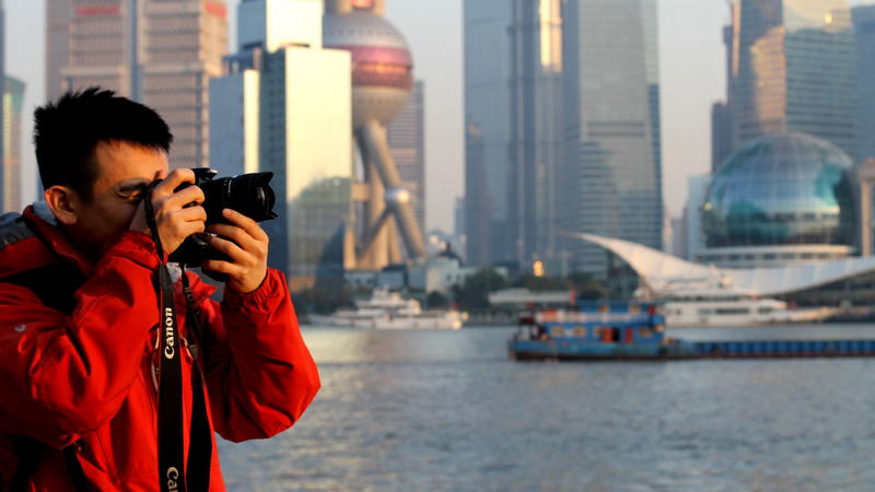 a man taking a picture of a city