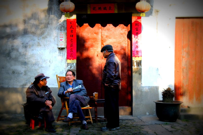 a man sitting in a chair next to a woman