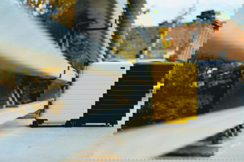 Yellow and black suitcase in an urban setting