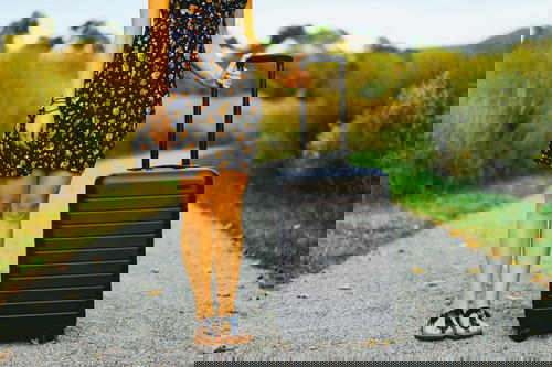 Woman holding an Away Suitcase during golden hour