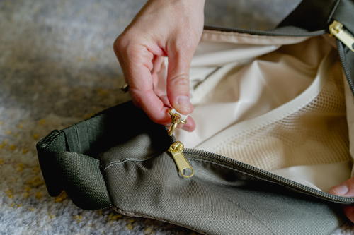 a person is opening a bag on the floor