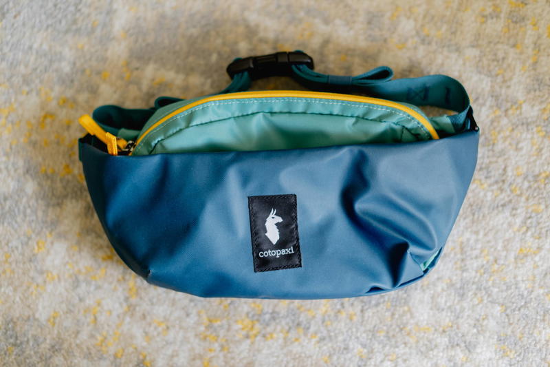 a blue and green bag on the floor