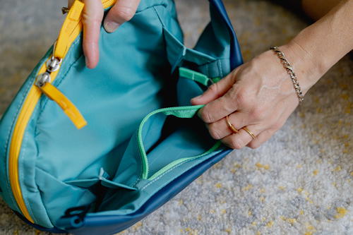 a person is putting something in a bag