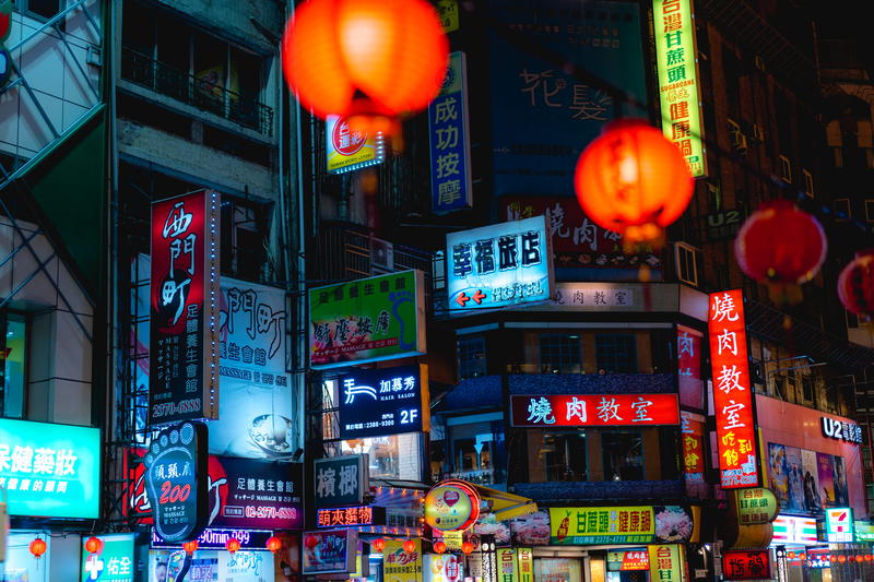 Neon Chinese signs and red lanterns lit up in a busy night scene in Taipei Taiwan
