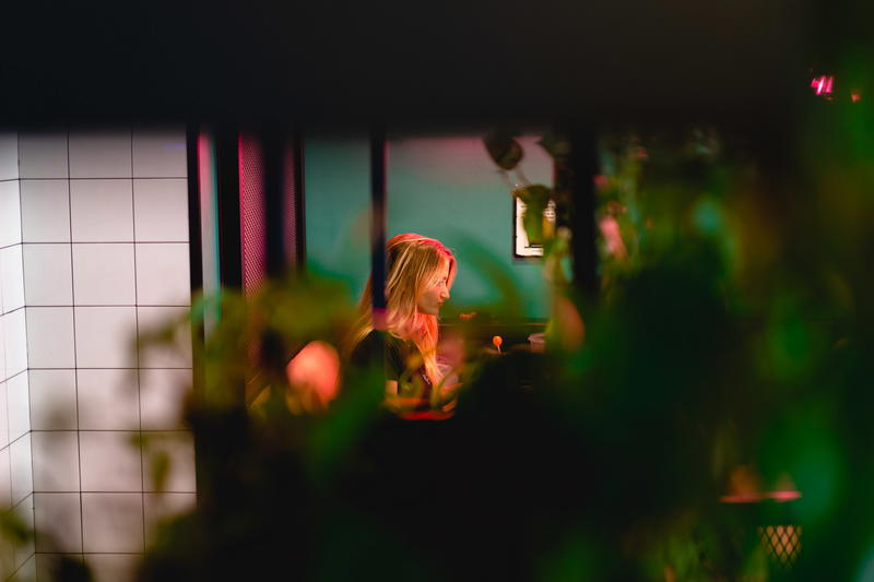 A woman is sitting at a table in a restaurant.