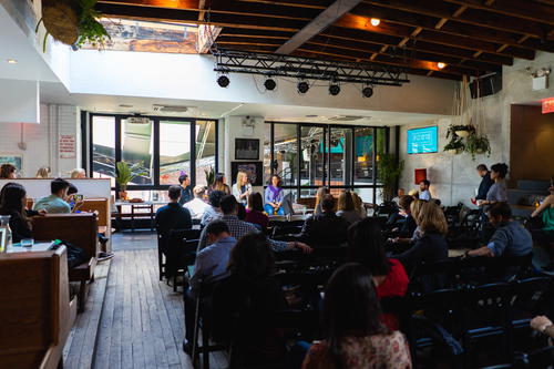 A group of people sitting in chairs in a room.