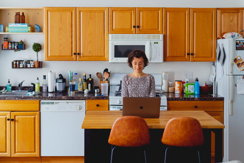 Woman working with a laptop in a kitchen
