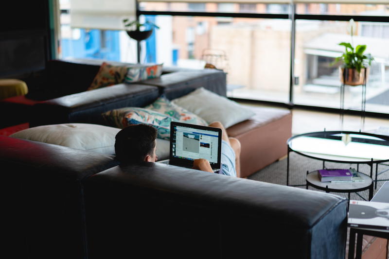 Man working on a couch in a coworking space