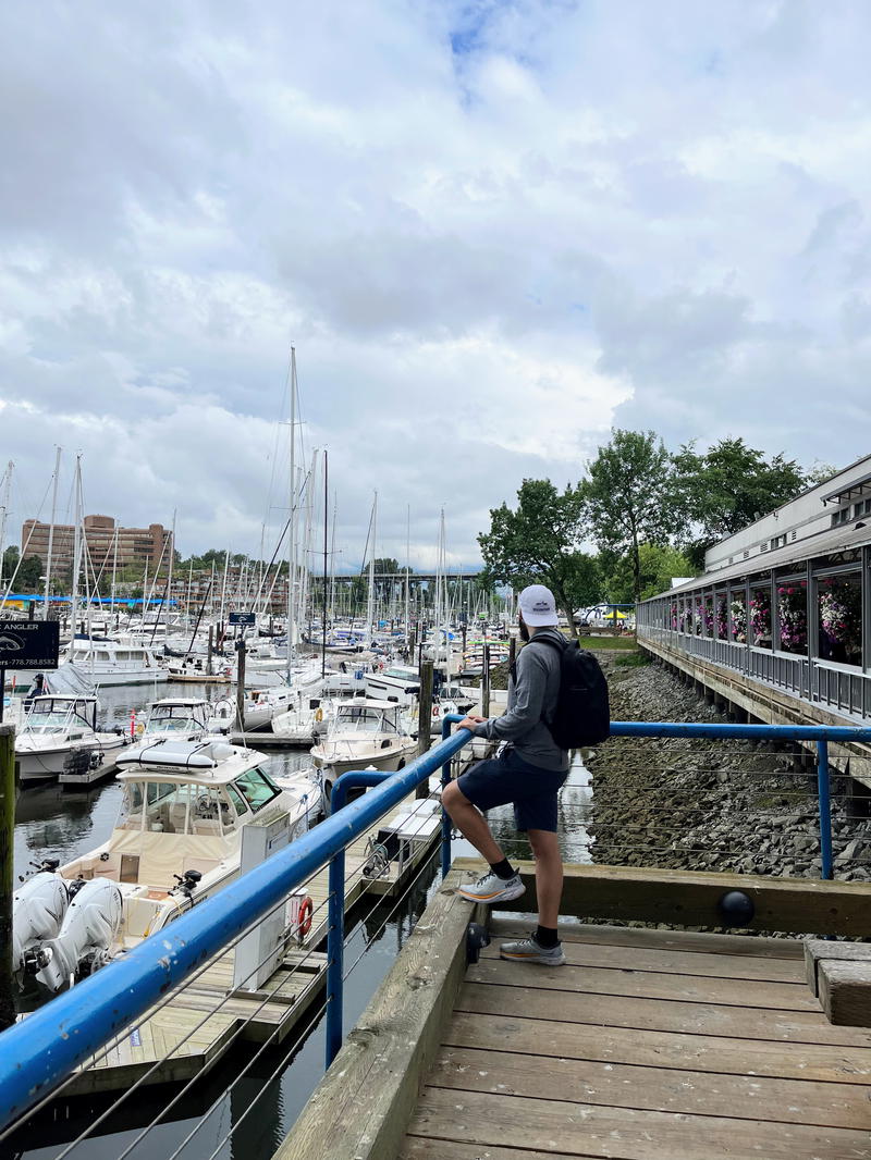 Man standing near boats wearing the Aer Fit Pack 3