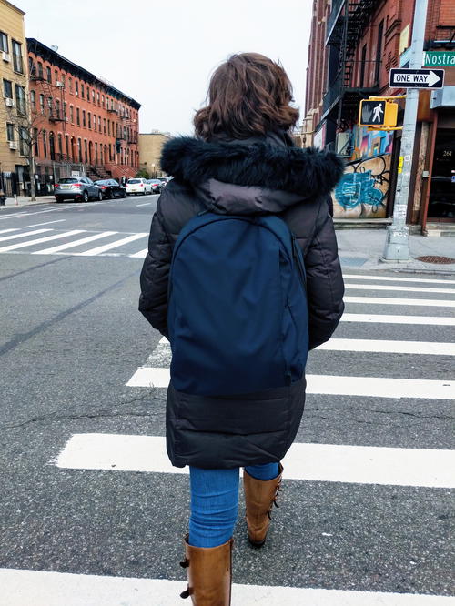 Using the small Away backpack for a daypack in the city while crossing the street