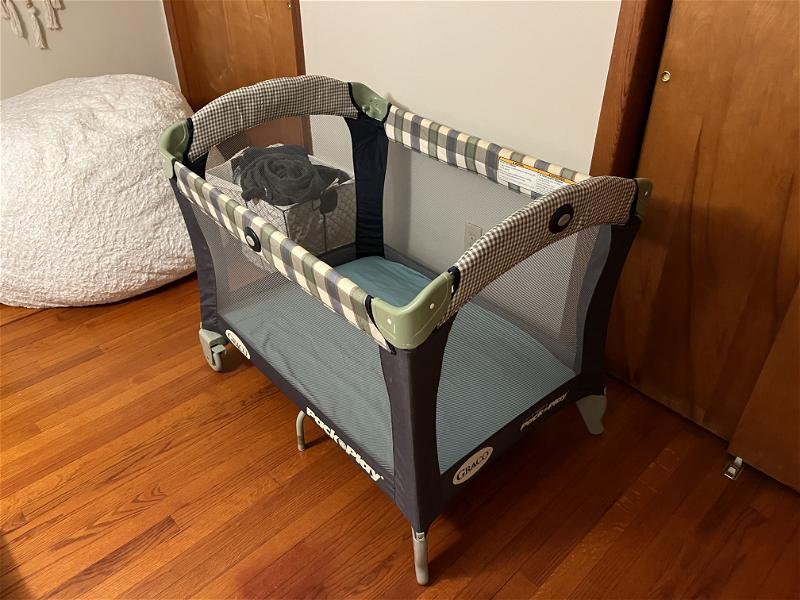 Graco Pack n Play assembled on a hard wood floor