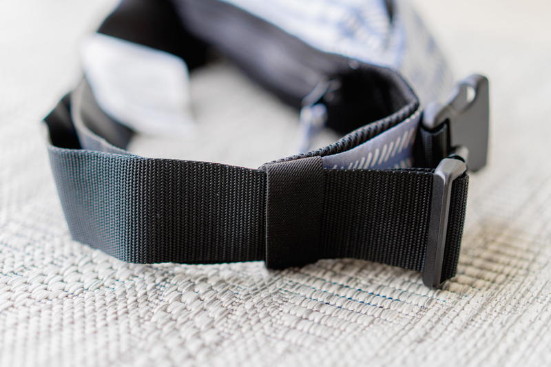 A close up of the buckle on the baby tula lite carrier.