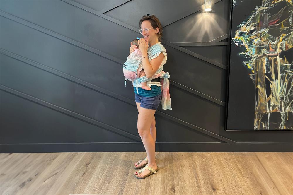 Woman using a Didymos baby carrier