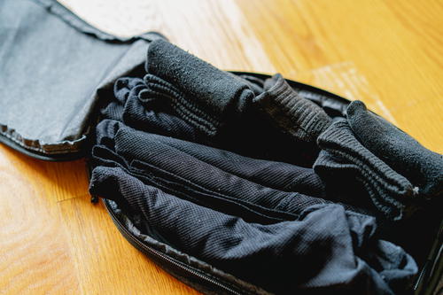 A peak design packing cube with socks and underwear packed inside.
