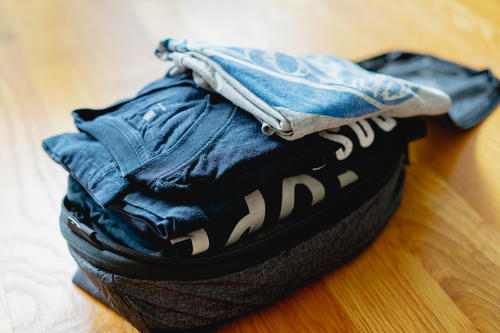 A fully packed peak design packing cube with tshirts.