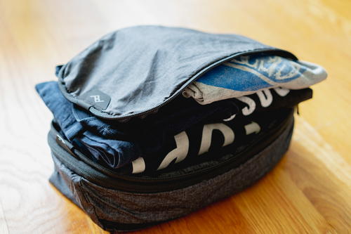 A fully packed peak design packing cube with tshirts.