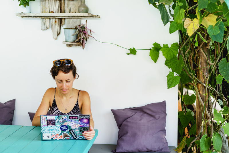 Woman using Dell XPS on a team table outside at a cafe