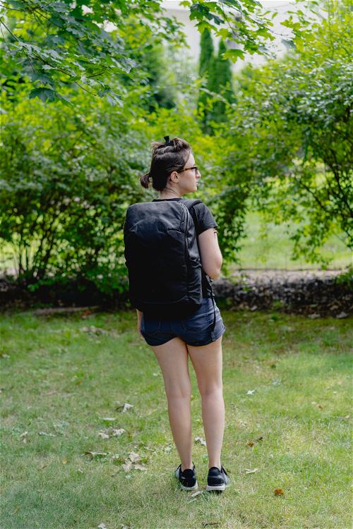 Woman wearing the Tortuga laptop backpack in black