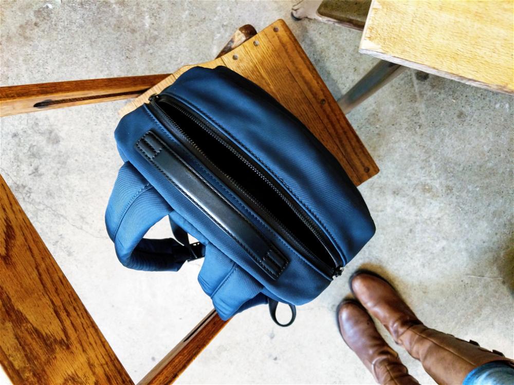 Blue Away Travel backpack on a wooden chair