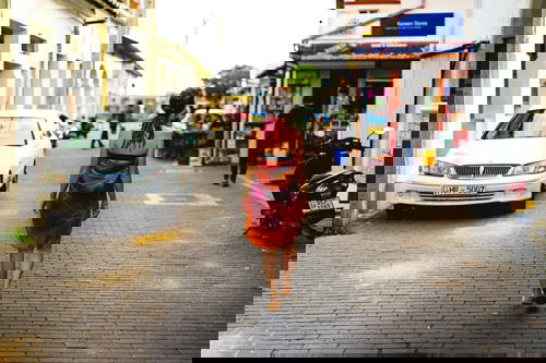 Backpacker traveler girl in Galle Sri Lanka walking in colonial street with colonial architecture