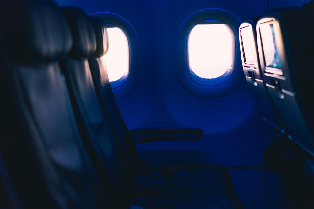 Dark empty airplane row tinted blue