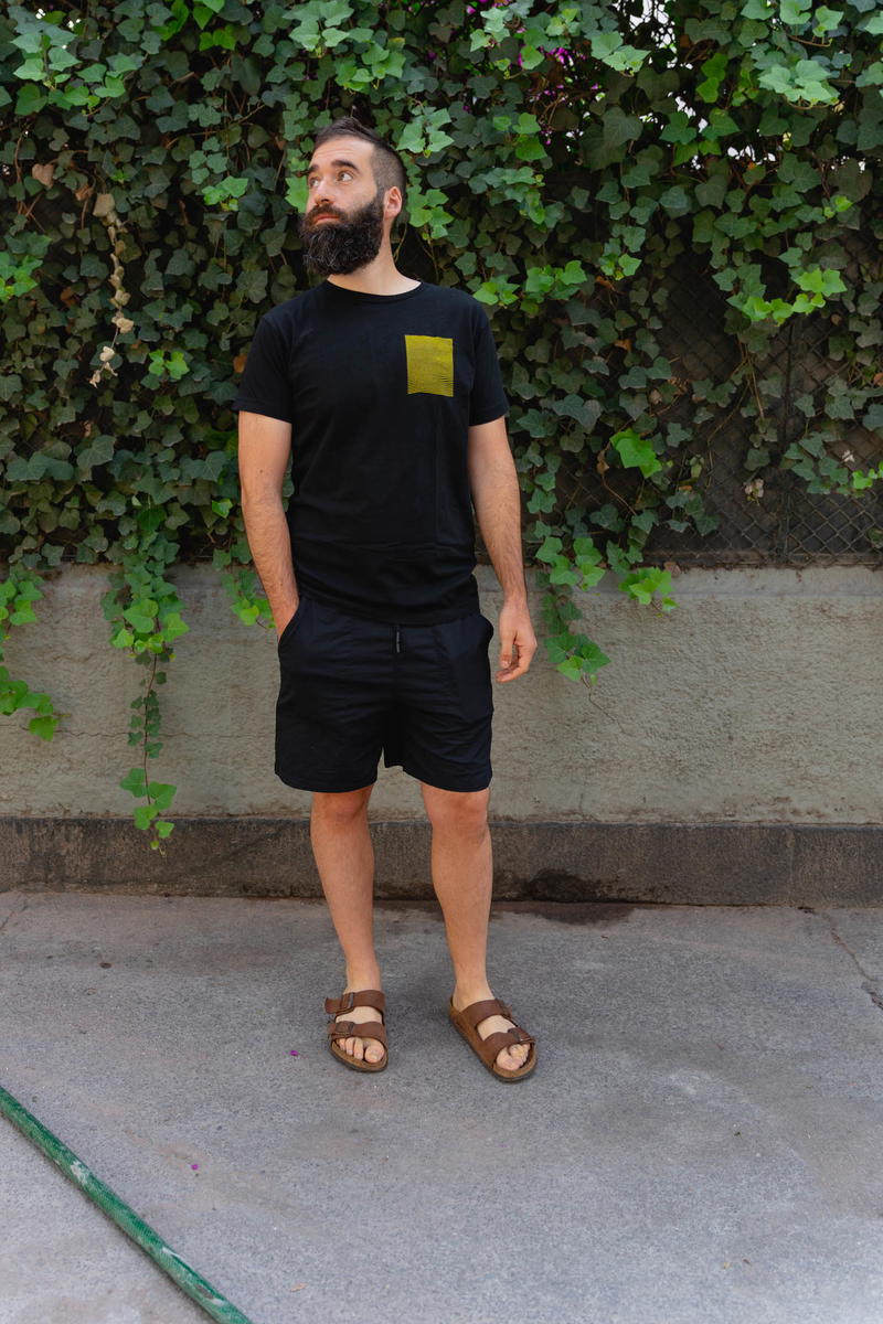 Man wearing a black t shirt and the DUER Weightless Poplin shorts