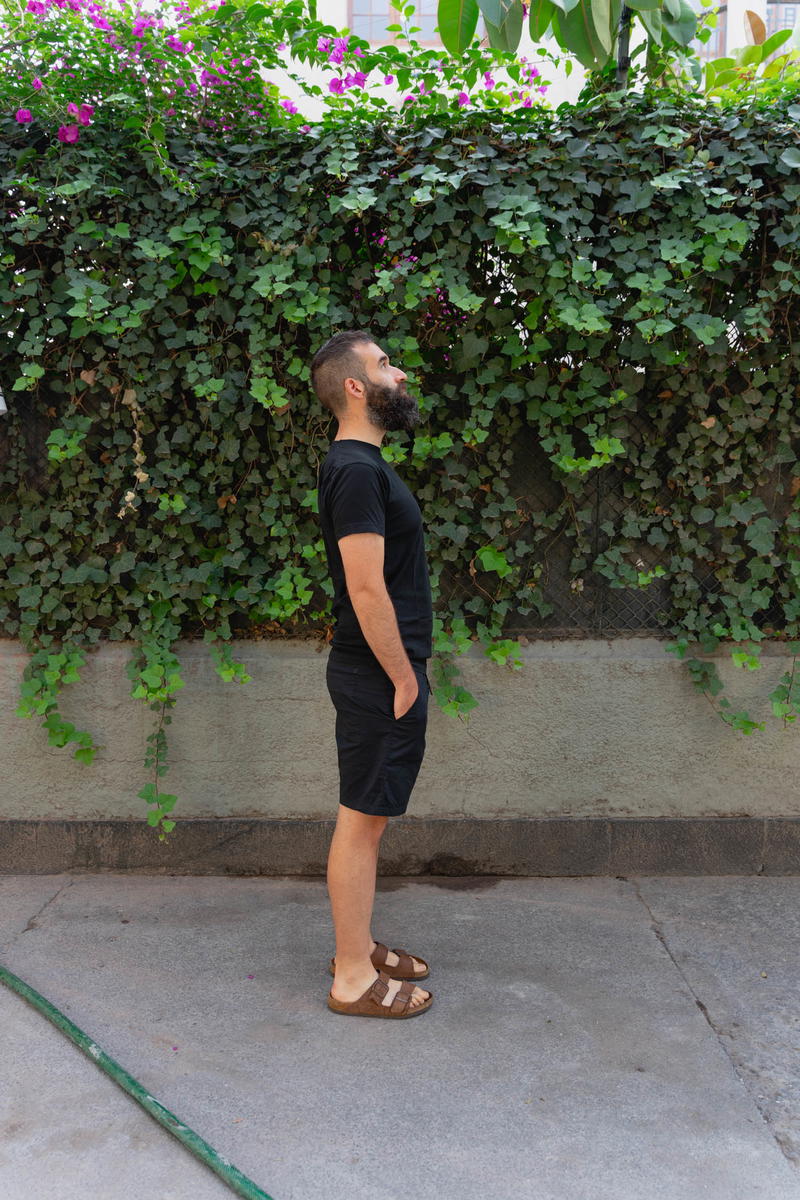 Man wearing a black t shirt and the DUER Weightless Poplin shorts