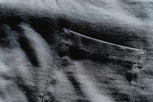 Close up of a black Mott & Bow t-shirt pocket