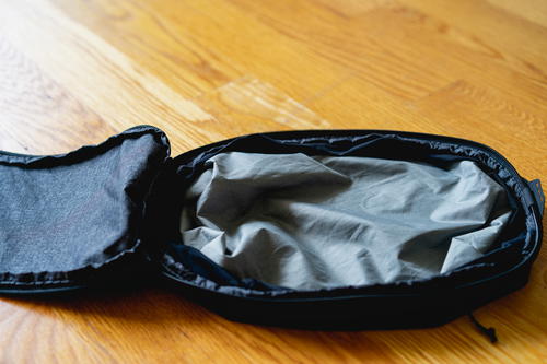 A small peak design packing cube open with nothing inside.