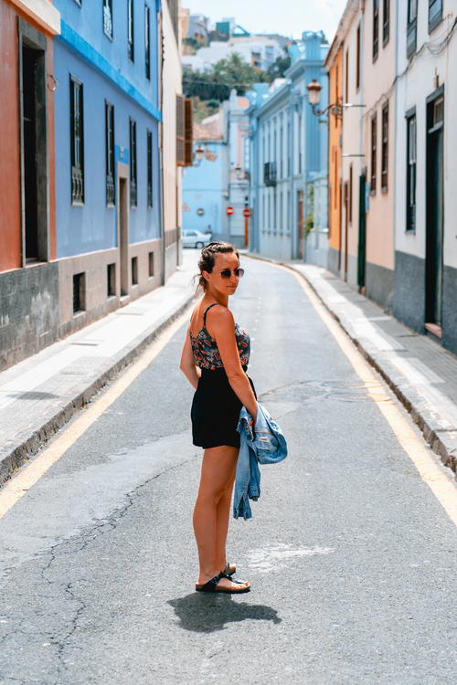 Woman standing in colorful colonial street in San Cristobal La Laguna tenerife canary islands spain