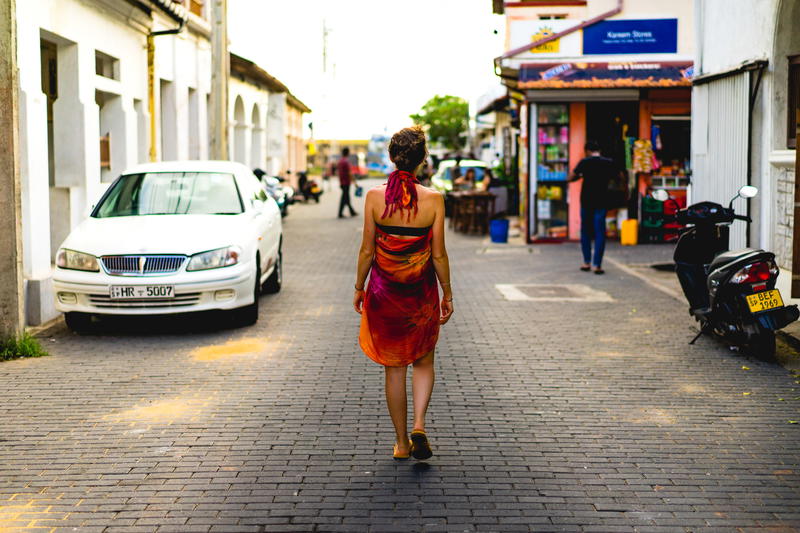 Backpacker traveler girl in Galle Sri Lanka walking in colonial street with colonial architecture