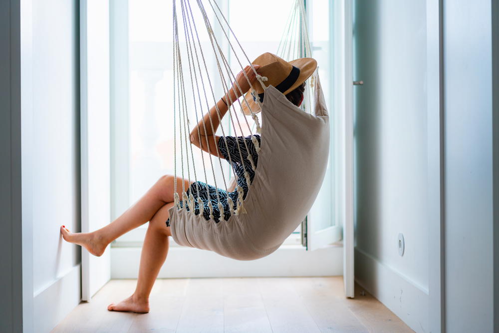 The Lisboans Lisbon Portugal best hotel apartment girl sitting in hanging swing in penthouse hotel room