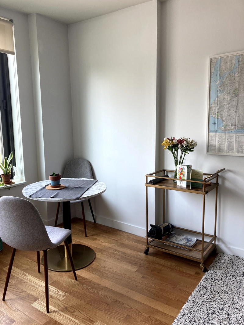 A small living room with a table and chairs.