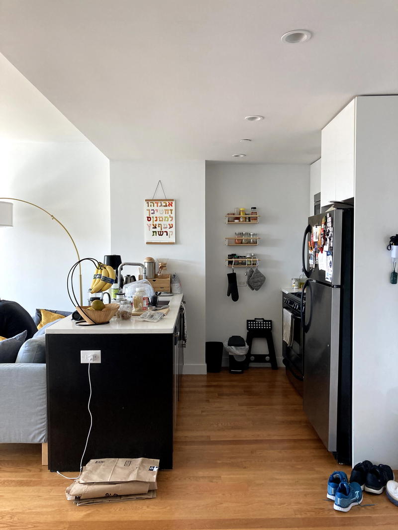 A kitchen with a refrigerator and a microwave.