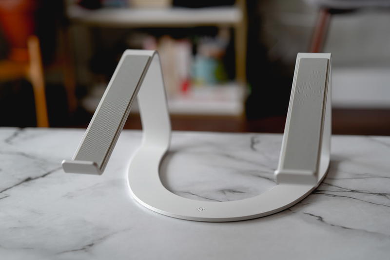A white laptop stand on a marble table.