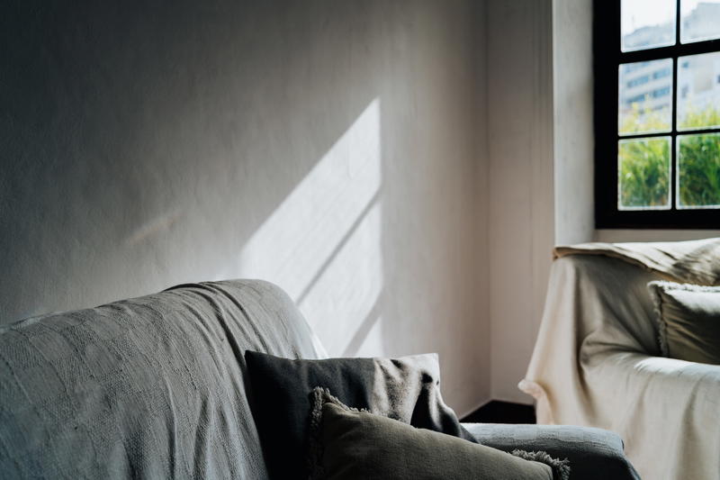 A couch in front of a window.