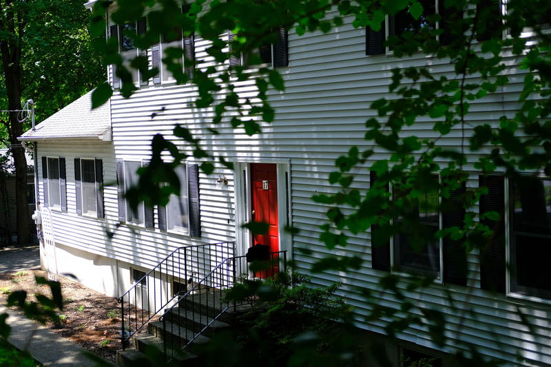A white house with a red door.