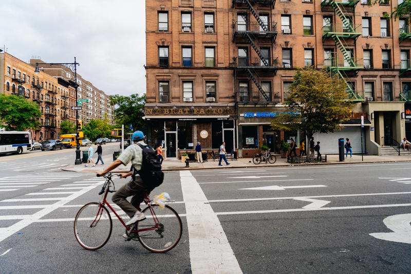 A person riding a bicycle on a city street.