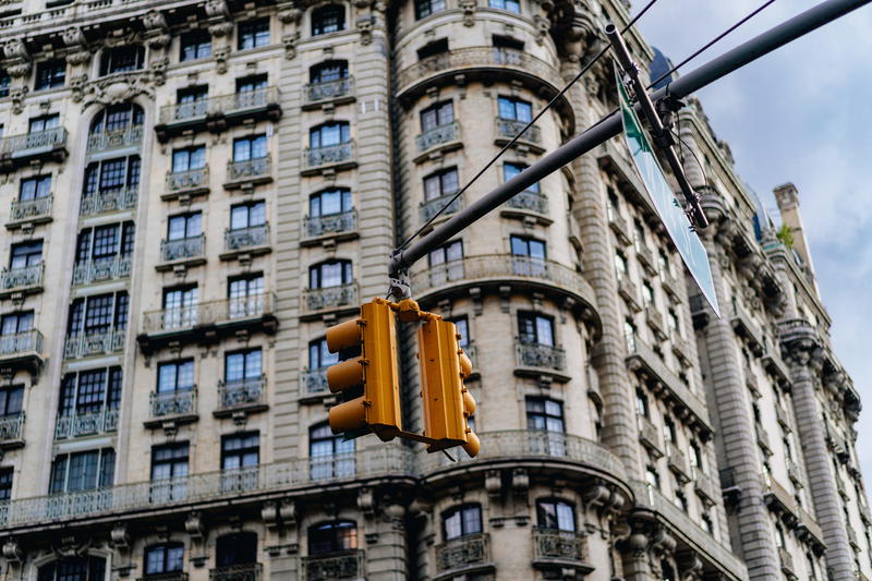 An ornate building with a traffic light in front of it.