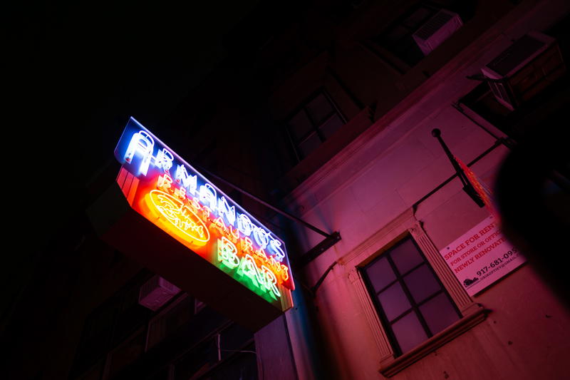 A neon sign on the side of a building.