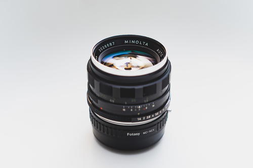 A camera lens sitting on top of a white surface.