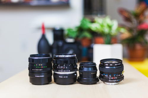 A group of camera lenses sitting on a table.