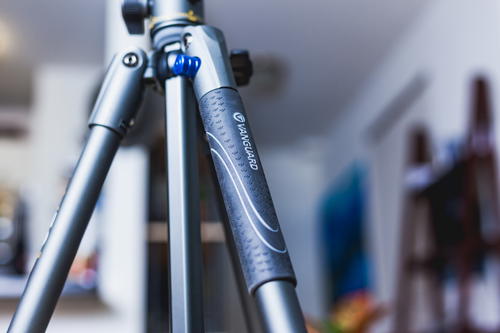 A close up of a tripod in a living room.