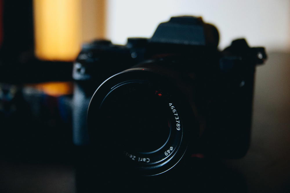 A dark image of a camera on a table.